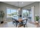 Elegant dining area with a modern chandelier, sliding glass doors, and backyard views at 22771 N 98Th Dr, Peoria, AZ 85383