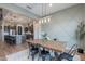 Dining area showcasing a wood table, modern lighting, and decorative wall trim at 22771 N 98Th Dr, Peoria, AZ 85383