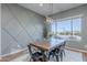 Inviting dining room with wood table, pendant lighting, and a large window offering scenic views at 22771 N 98Th Dr, Peoria, AZ 85383