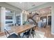 Dining area features a wood table, contemporary lighting, and seamless flow to the outdoor living space at 22771 N 98Th Dr, Peoria, AZ 85383