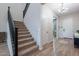 Inviting entryway with staircase and hardwood floors at 22771 N 98Th Dr, Peoria, AZ 85383
