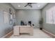 An organized and modern home office space featuring a large desk and a calming color palette at 22771 N 98Th Dr, Peoria, AZ 85383