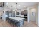 Gourmet kitchen with a large island, stainless steel appliances, modern pendant lights, and lots of storage at 22771 N 98Th Dr, Peoria, AZ 85383