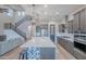 Bright open concept kitchen with a large center island, stainless appliances, and modern finishes at 22771 N 98Th Dr, Peoria, AZ 85383
