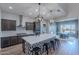 Spacious kitchen with a large island, stainless steel appliances, and stylish pendant lighting at 22771 N 98Th Dr, Peoria, AZ 85383