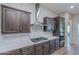 Modern kitchen featuring stainless steel appliances, sleek countertops, and dark wood cabinetry at 22771 N 98Th Dr, Peoria, AZ 85383