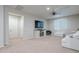 Cozy living room featuring plush carpeting, a ceiling fan, and a modern entertainment center at 22771 N 98Th Dr, Peoria, AZ 85383