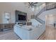 A spacious living room featuring a modern fireplace, built in cabinets, and staircase to the upper level at 22771 N 98Th Dr, Peoria, AZ 85383