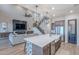 Bright, open-concept living space with high ceilings, fireplace and seamless transition to kitchen at 22771 N 98Th Dr, Peoria, AZ 85383
