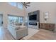 Cozy living room with a modern fireplace, comfortable seating, and a soaring ceiling at 22771 N 98Th Dr, Peoria, AZ 85383