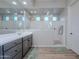 Bright and airy main bathroom with double sinks, a spacious walk-in shower with multiple shower heads, and modern fixtures at 22771 N 98Th Dr, Peoria, AZ 85383