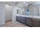 Spacious main bathroom featuring double sinks, a large mirror, and contemporary finishes throughout at 22771 N 98Th Dr, Peoria, AZ 85383