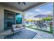 Covered patio with outdoor seating, a ceiling fan, and views of the pool with a waterfall feature at 22771 N 98Th Dr, Peoria, AZ 85383