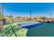 A pair of pickleball courts featuring new surfaces, modern net systems and perimeter fencing for safety and enjoyment at 22771 N 98Th Dr, Peoria, AZ 85383