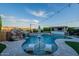 Resort-style pool with a waterfall feature, a swim-up bar, and comfortable lounging area at 22771 N 98Th Dr, Peoria, AZ 85383