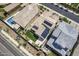 Aerial view of properties showcasing solar panels, backyard artificial grass and inground pool at 22960 N 94Th Ln, Peoria, AZ 85383