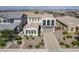 Aerial view of stucco home featuring well-manicured landscaping and a two-car garage at 22960 N 94Th Ln, Peoria, AZ 85383