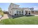 Spacious backyard with lush artificial grass and a covered patio area at 22960 N 94Th Ln, Peoria, AZ 85383