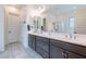 Elegant bathroom featuring dual sinks, generous counter space, and framed mirrors at 22960 N 94Th Ln, Peoria, AZ 85383