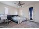 Cozy bedroom with carpet flooring and a door to the backyard at 22960 N 94Th Ln, Peoria, AZ 85383