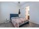 Comfortable bedroom with carpet flooring and a bathroom entrance at 22960 N 94Th Ln, Peoria, AZ 85383
