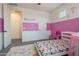 bedroom featuring a playful pink theme and a large window at 22960 N 94Th Ln, Peoria, AZ 85383