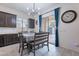 Open kitchen dining area with modern furniture, bright lighting, and neutral paint at 22960 N 94Th Ln, Peoria, AZ 85383