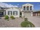 Front yard with desert landscaping, and a home with two-car garage, and two-story architecture at 22960 N 94Th Ln, Peoria, AZ 85383