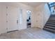 Welcoming foyer features neutral paint, tile floors and staircase leading to upper level at 22960 N 94Th Ln, Peoria, AZ 85383