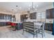 Full open kitchen concept with bar seating, and a formal dining area adjacent to a large kitchen at 22960 N 94Th Ln, Peoria, AZ 85383