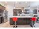 Open kitchen with central island, stainless steel appliances, gray cabinetry, and tile floors at 22960 N 94Th Ln, Peoria, AZ 85383