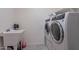 Functional laundry room equipped with modern appliances and ample counter space at 22960 N 94Th Ln, Peoria, AZ 85383