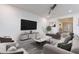 Contemporary living room featuring modern furniture, neutral colors, and a ceiling fan at 22960 N 94Th Ln, Peoria, AZ 85383