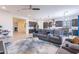 Open-concept living area flows into a modern kitchen featuring gray cabinets and stainless steel appliances at 22960 N 94Th Ln, Peoria, AZ 85383