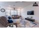 Bright, virtually staged living room features neutral tones, modern furnishings, and ample natural light at 22960 N 94Th Ln, Peoria, AZ 85383