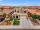 Aerial shot of a charming two-story home featuring a well-maintained lawn, and three-car garage at 2322 E Mews Rd, Gilbert, AZ 85298