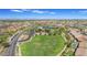 Wide aerial view of neighborhood featuring large green space and community lake at 2322 E Mews Rd, Gilbert, AZ 85298