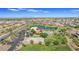 Expansive aerial view of community amenities including a lake, pool, clubhouse, parking, and basketball court at 2322 E Mews Rd, Gilbert, AZ 85298