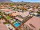 Aerial view of a home with a private backyard featuring a pool, lush landscaping, and outdoor seating area at 2322 E Mews Rd, Gilbert, AZ 85298
