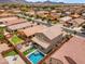 Aerial view of a home with a private backyard featuring a pool, lush landscaping, and outdoor seating area at 2322 E Mews Rd, Gilbert, AZ 85298