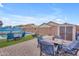 Inviting backyard with a dining set, lounge chairs, mural art, and well-manicured landscape at 2322 E Mews Rd, Gilbert, AZ 85298