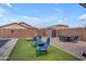 The backyard boasts a pool, green turf, a shed, and patio furniture at 2322 E Mews Rd, Gilbert, AZ 85298
