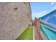 Side yard featuring narrow strip of artificial turf, and wall with mural at 2322 E Mews Rd, Gilbert, AZ 85298