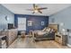 This bedroom features a ceiling fan, wood furniture, and hardwood floors at 2322 E Mews Rd, Gilbert, AZ 85298