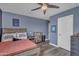 This cozy bedroom boasts modern decor, a ceiling fan and a built-in bookshelf at 2322 E Mews Rd, Gilbert, AZ 85298