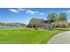 Beautiful community clubhouse overlooking a well-manicured lawn and the lake with fountains at 2322 E Mews Rd, Gilbert, AZ 85298
