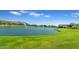 Scenic view of community lake with fountains and lush green lawn at 2322 E Mews Rd, Gilbert, AZ 85298