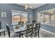 Bright dining area boasts a view of the backyard pool and has a wood table with seating for six at 2322 E Mews Rd, Gilbert, AZ 85298