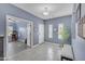 An entryway with neutral blue walls, tile floors, and views into another room at 2322 E Mews Rd, Gilbert, AZ 85298