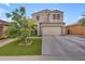Beautiful two-story home with a well-maintained lawn and landscaping offers appealing curb appeal at 2322 E Mews Rd, Gilbert, AZ 85298